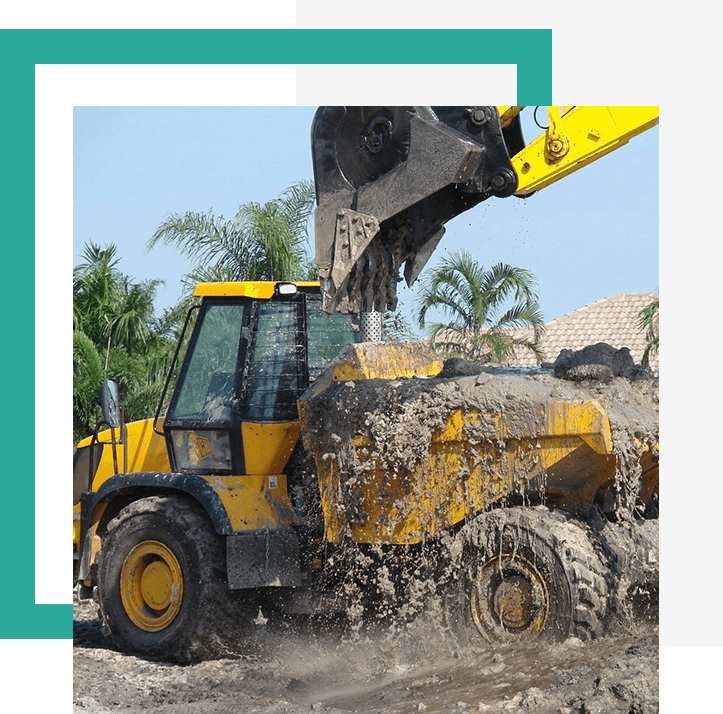 Yellow excavator pouring dirt into dump truck.