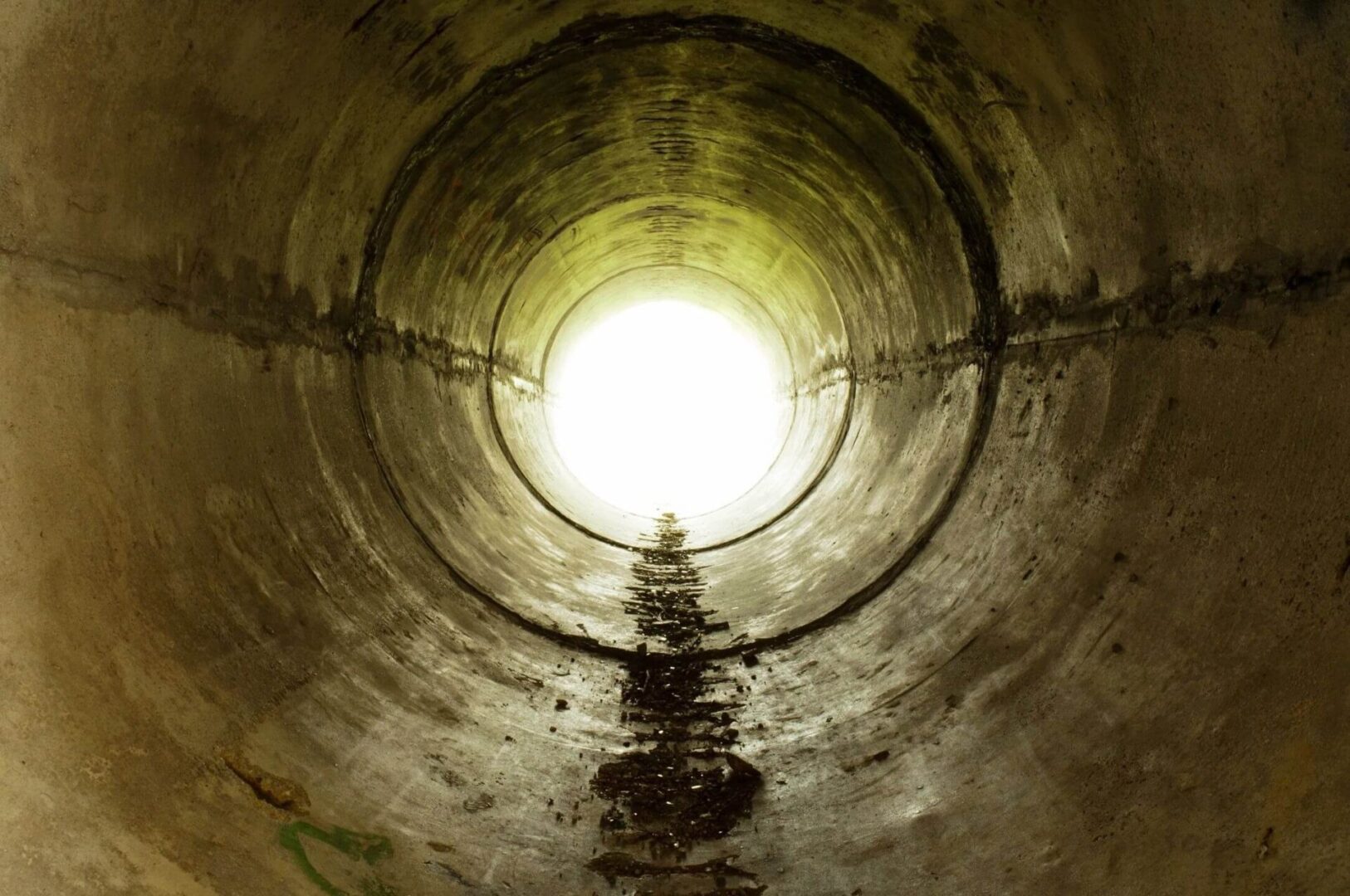 Inside view of a circular concrete tunnel.