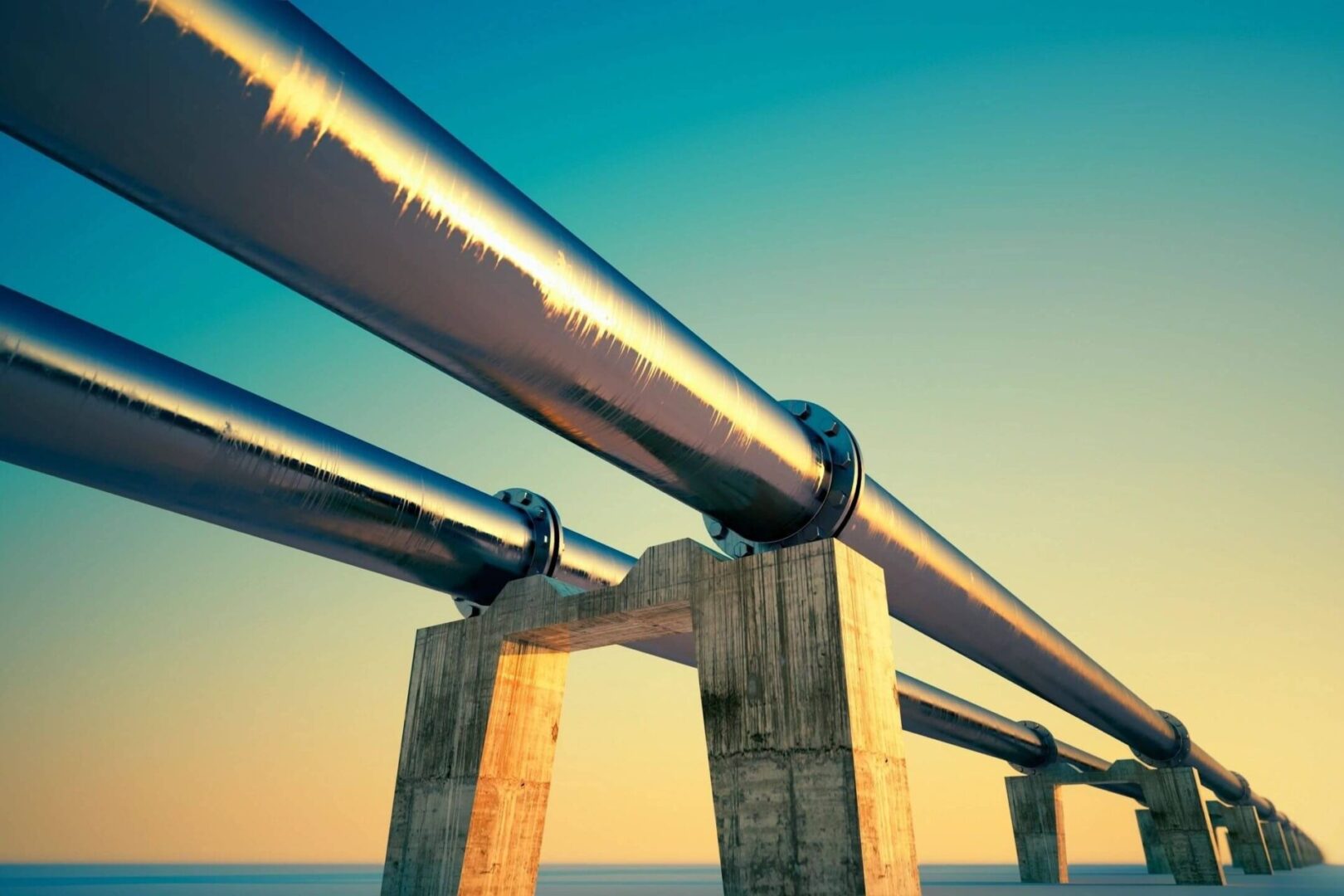 Large industrial pipes on concrete supports.